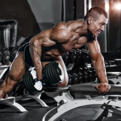 Athlete Muscular Bodybuilder Training Back With Dumbbell In The Gym Omg