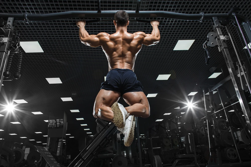 Athlete Muscular Fitness Male Model Pulling Up On Horizontal Bar