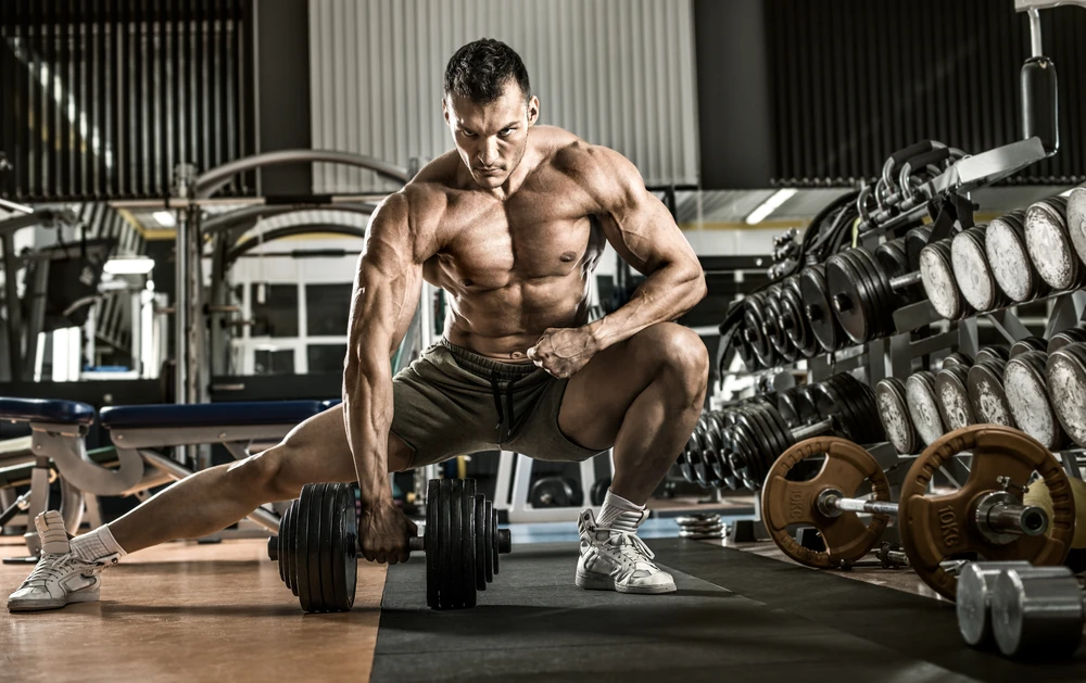 Man Bodybuilder Execute Exercise With Dumbbells Inside Gym Horizontal